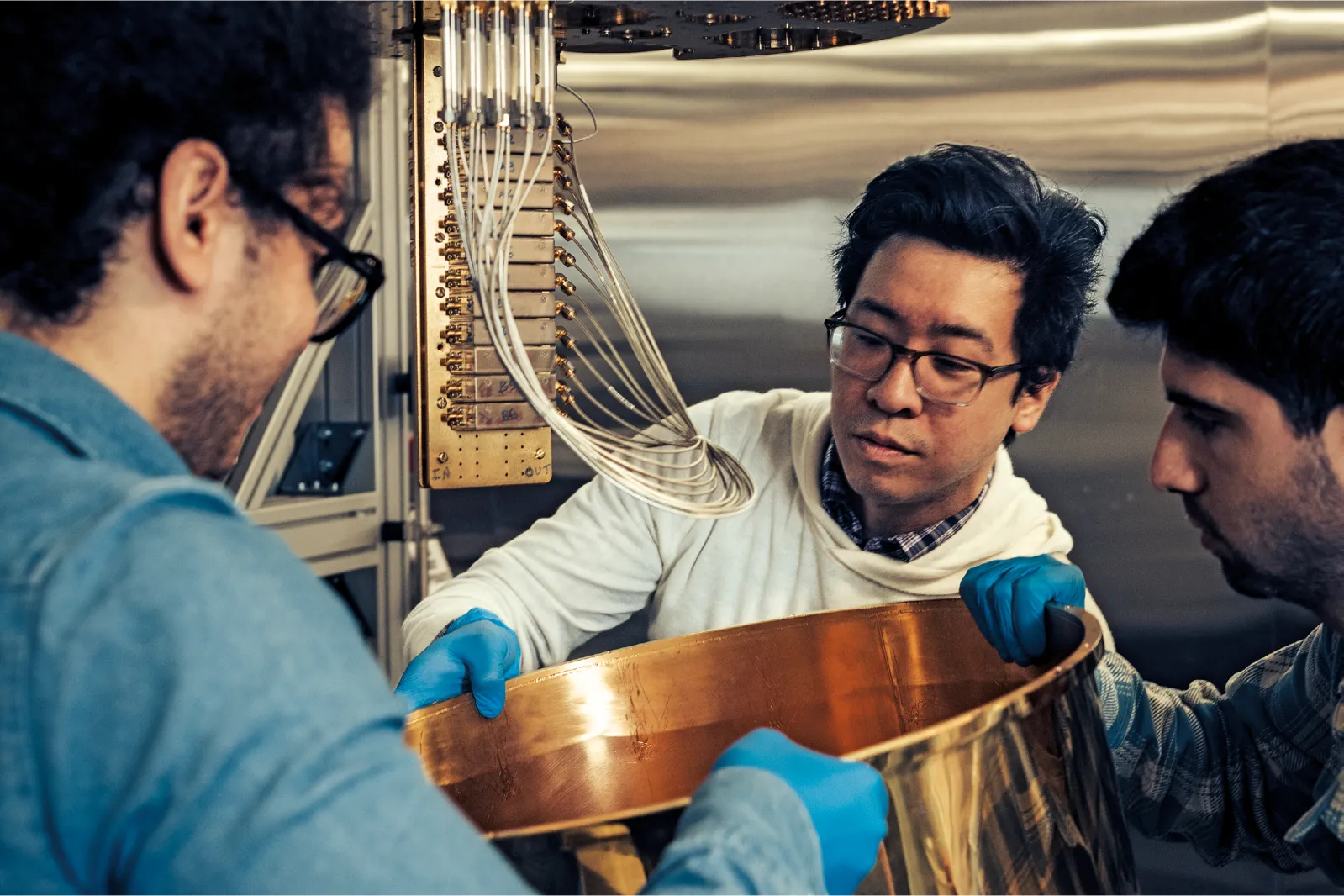 IBM researchers Cyrus Zeledon (left), IBM CTO of Quantum-Centric Supercomputing and IBM Fellow Jerry Chow (middle); and Liran Shirizly (right) begin installing thermal shields in preparation for cool down; IBM Thomas J Watson Research Lab; 1101 Kitchawan Road, Yorktown Heights, New York, June 23, 2026; Jerry Chow - IBM CTO of Quantum-Centric Supercomputing and IBM Fellow
