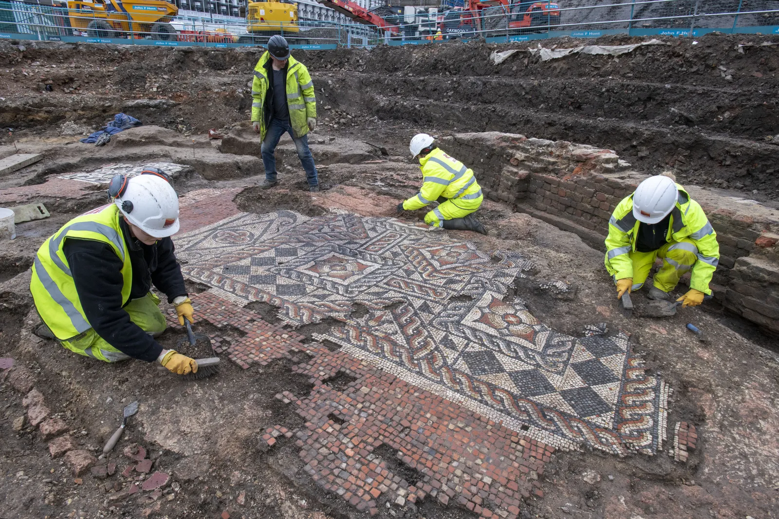 MOLA archaeologists work on the Roman mosaic.