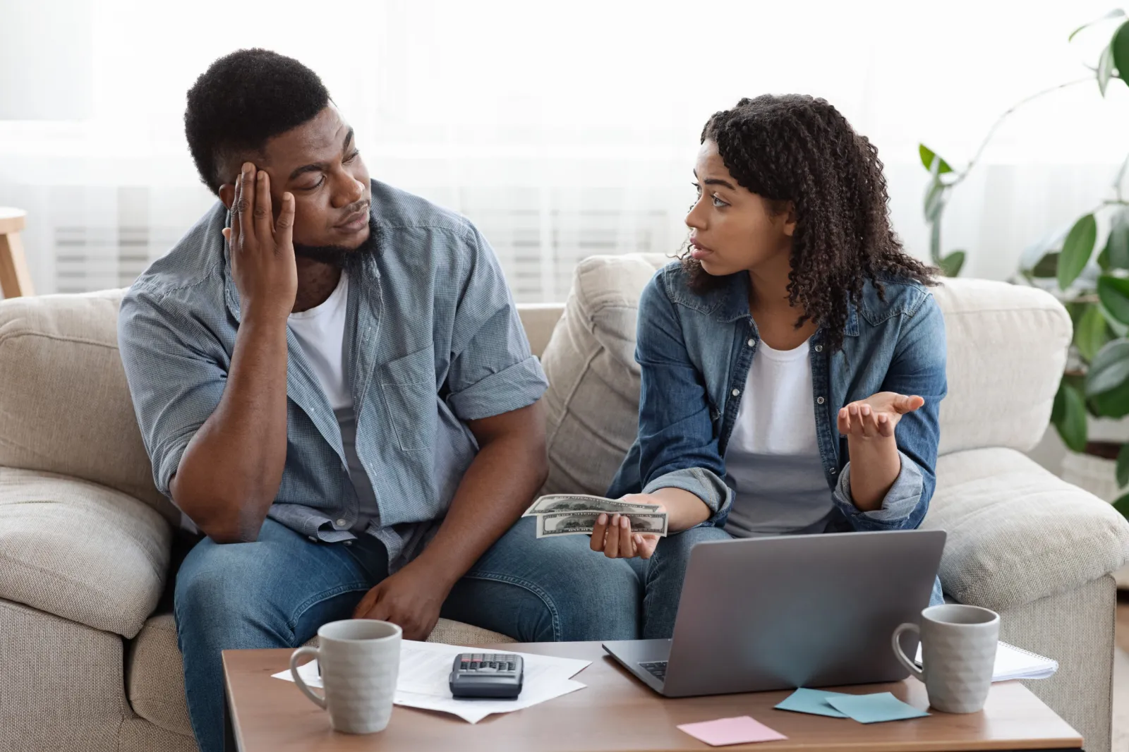 Couple looking at laptop discussing finances.