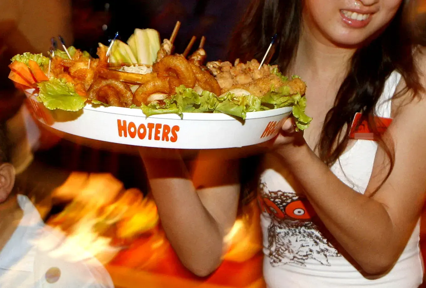 Hooters Waitress Serving Food