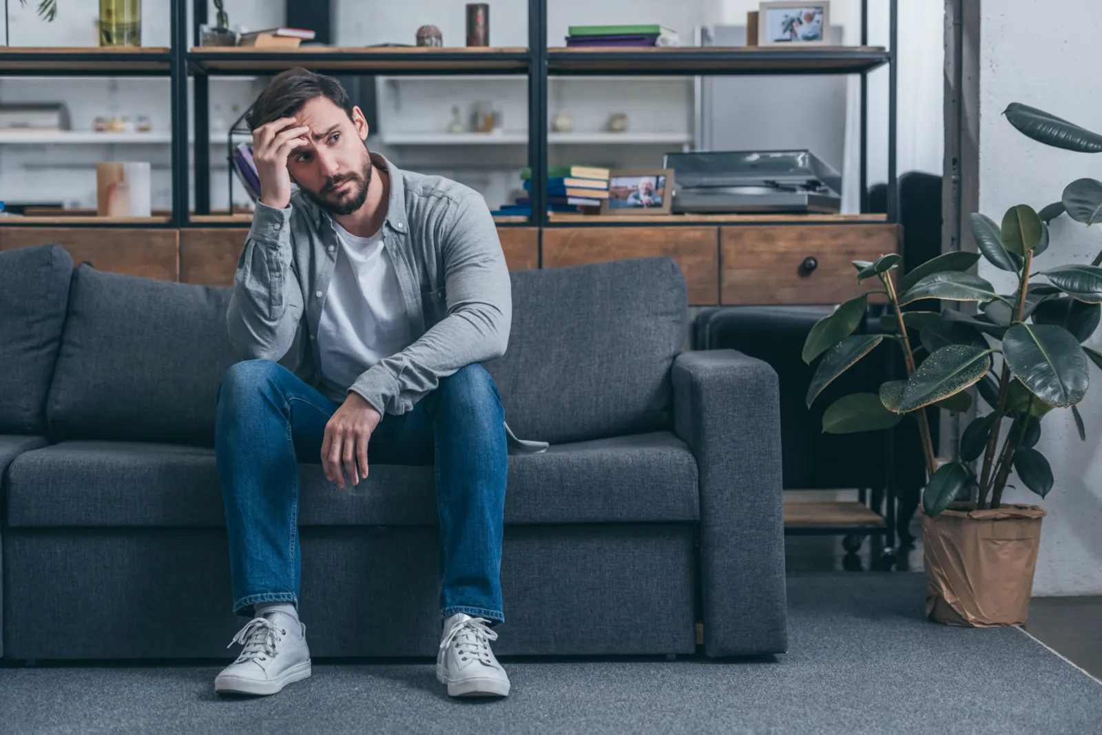 Man Looks Stressed On Couch