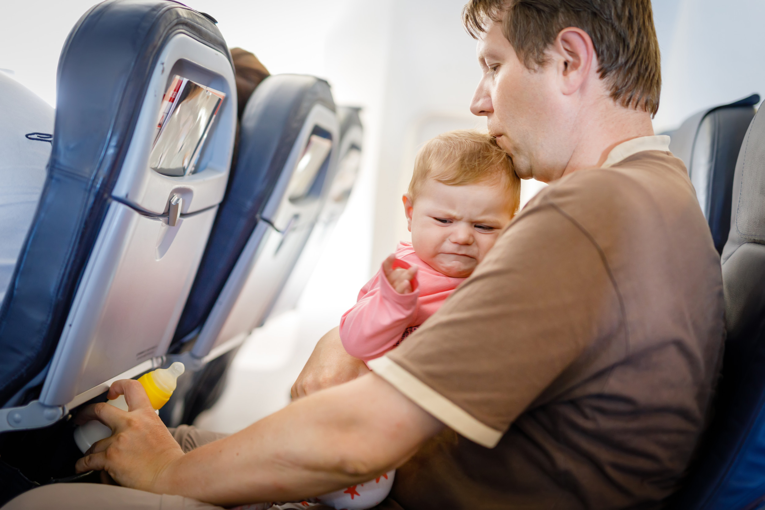Woman Offers to Hold Fussy Baby on Plane—Mom's Response Stuns: 'Piece of Work'