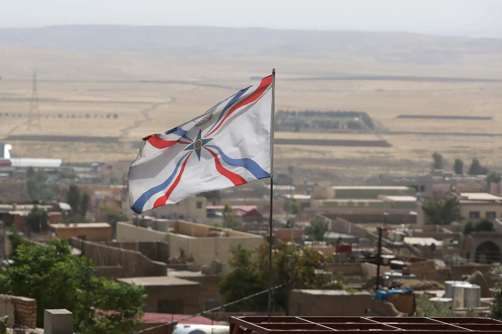 The Assyrian flag flutters