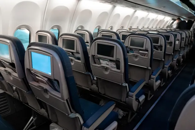 Rows of empty seats on a plane.
