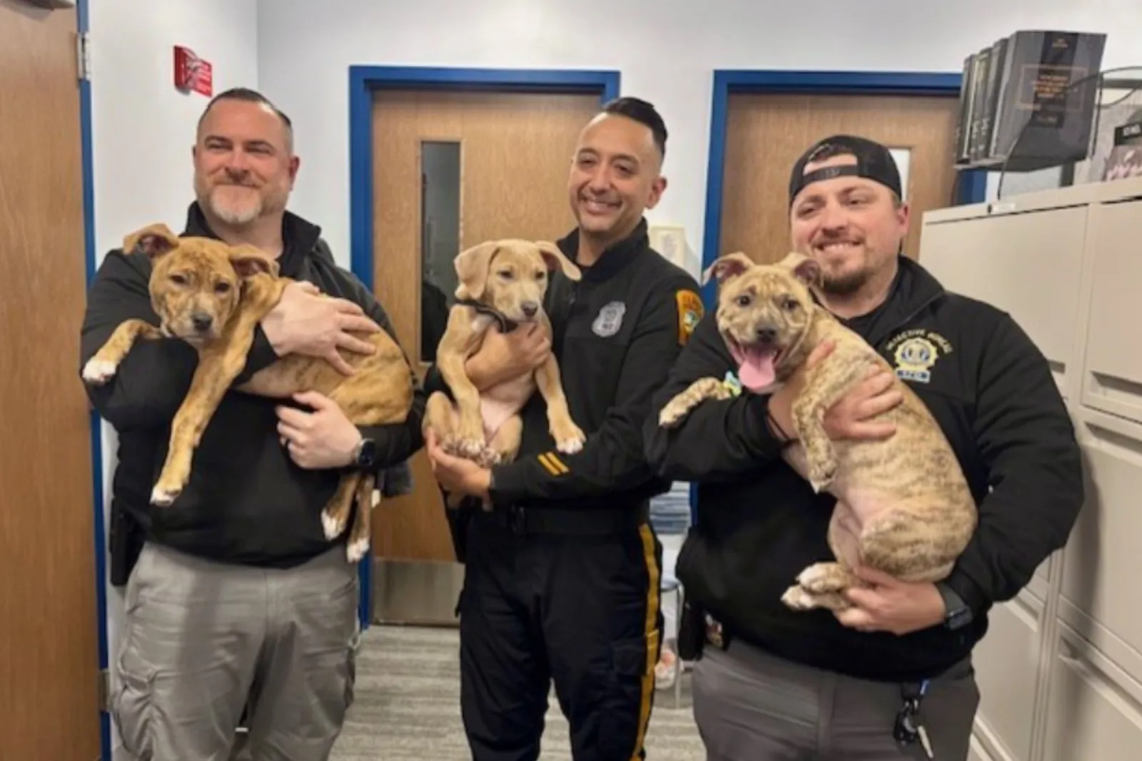 Officers with adopted puppies