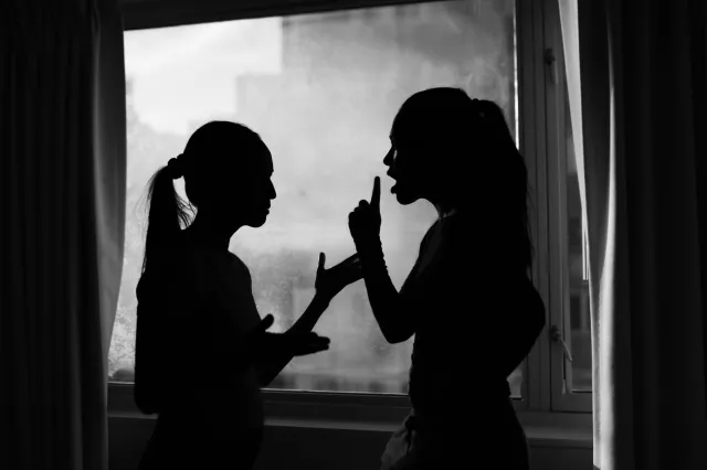 Women Argue In Front Of Window