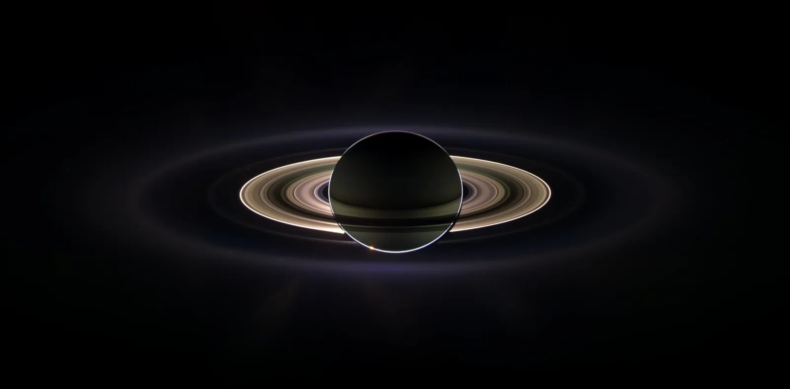 Saturn and its moon Tethys, Cassini spacecraft image. Tethys is the small  round object just below and left of centre, above Saturn's rings. Tethys is  Stock Photo - Alamy, image size:1600x789