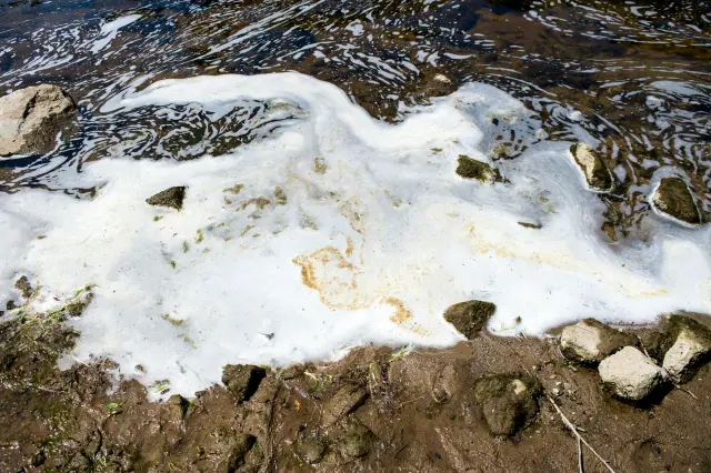 Foam filled with PFAS chemicals gathers at the Van Etten Creek dam in Oscoda Township, Michigan, near Wurtsmith Air Force Base in 2018.