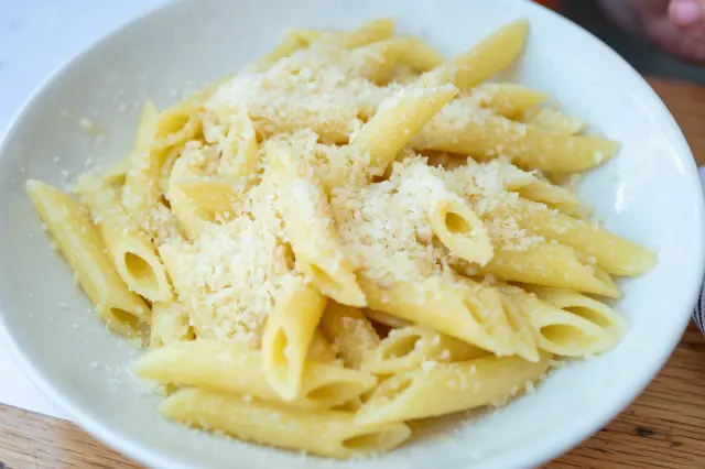 Close-up of a bowl of penne pasta noodles with butter and cheese, San Ramon, California, June 11, 2025