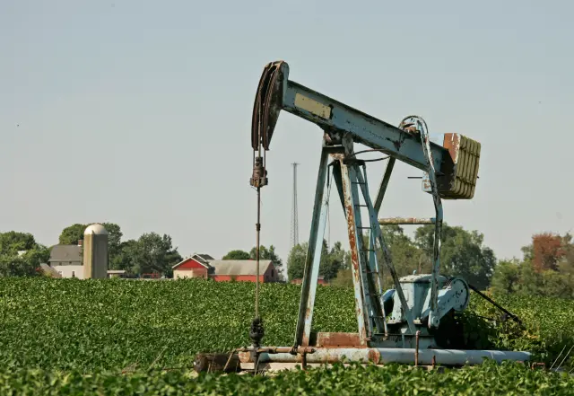 An oil well pump operates in the middle of a soybean field in rural Stark County near Hartville, Ohio in 2008.