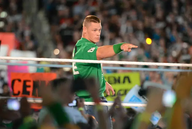 wwe star john cena in ring points to fans