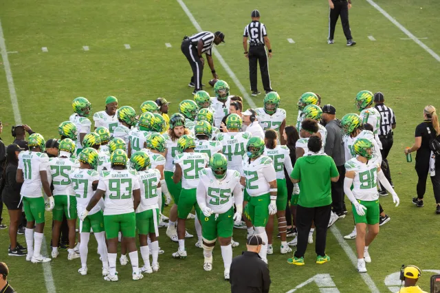 The Oregon Ducks huddle on the field during a Pac-12 NCAA college football game against the Stanford Cardinal