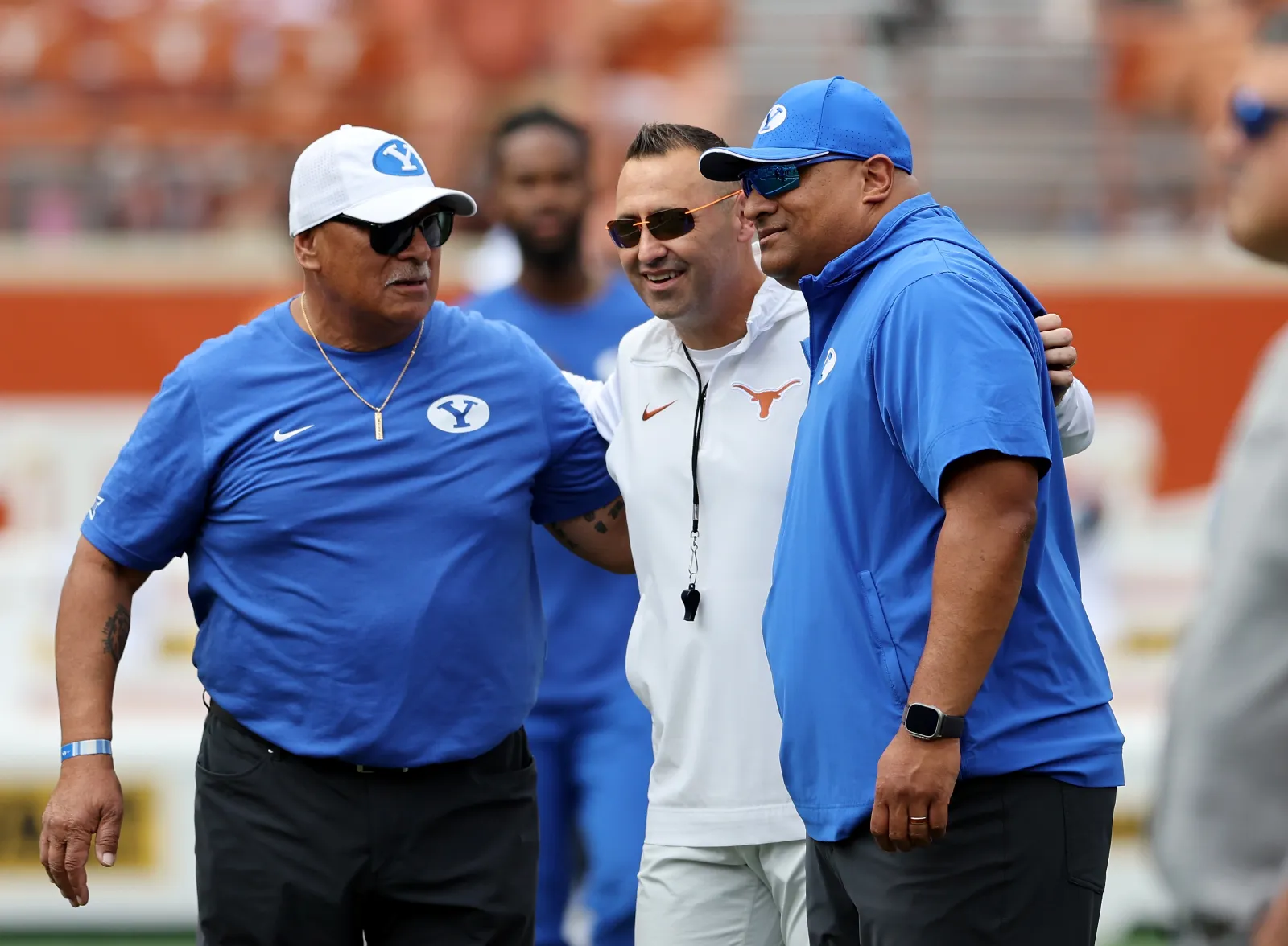 College football head coach Steve Sarkisian of the Texas Longhorns talks with head coach Kalani Sitake of the Brigham Young Cougars