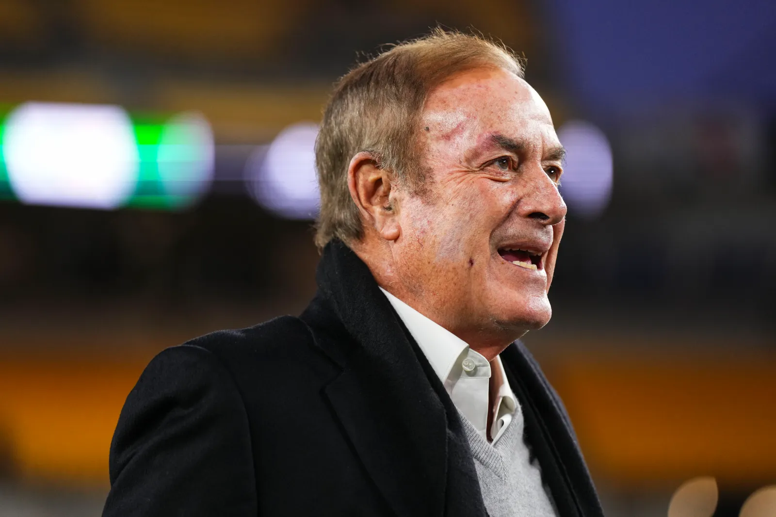 Al Michaels looks on from the sideline prior to an NFL football game