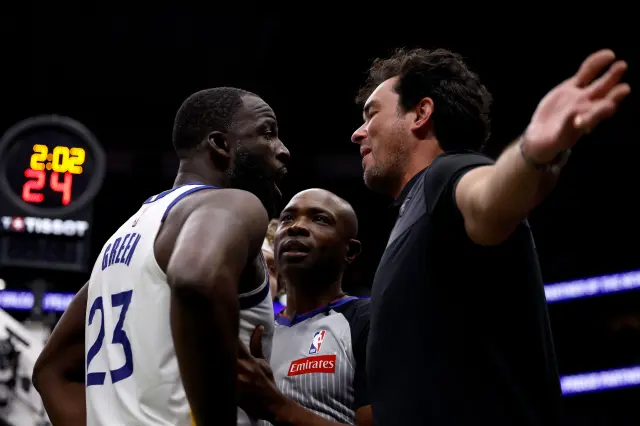 Golden State Warriors star Draymond Green talks to a fan at Pelicans game