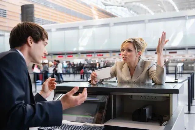 Woman at an airport check-in counter.