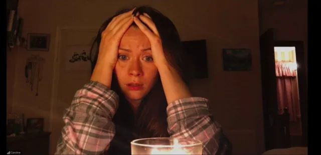 A woman looks sad with her head in her hands