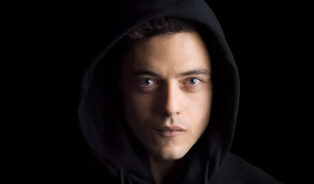 A man in a hood against a black background