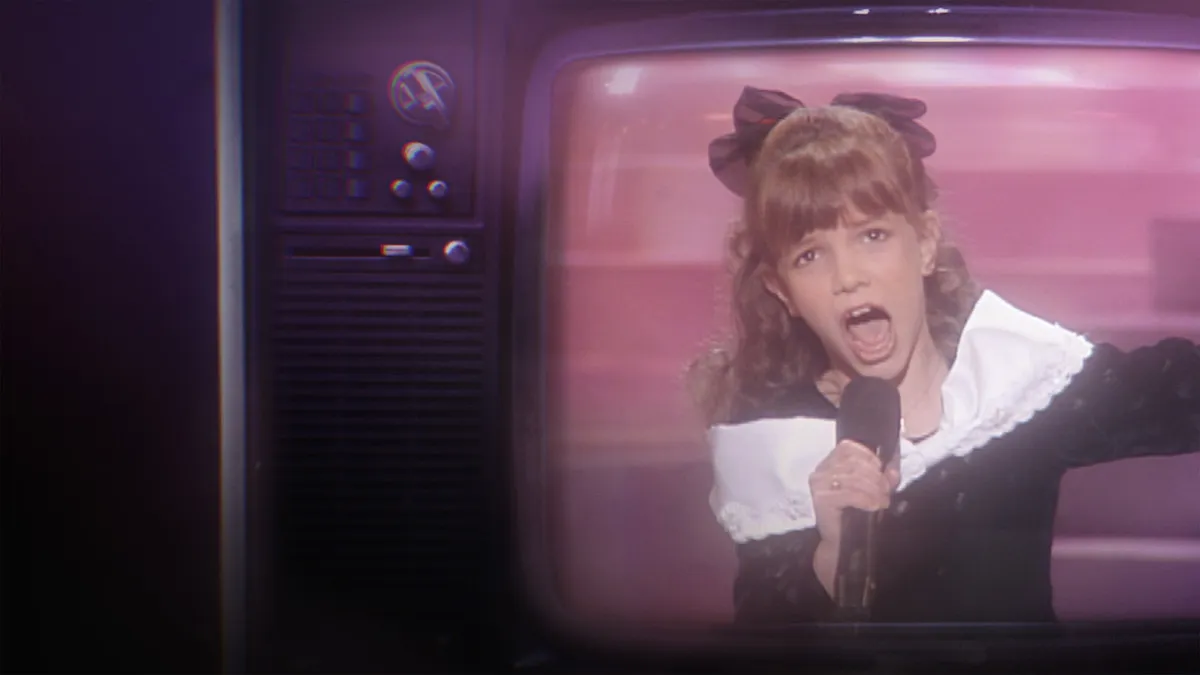 A young Britney Spears singing on stage