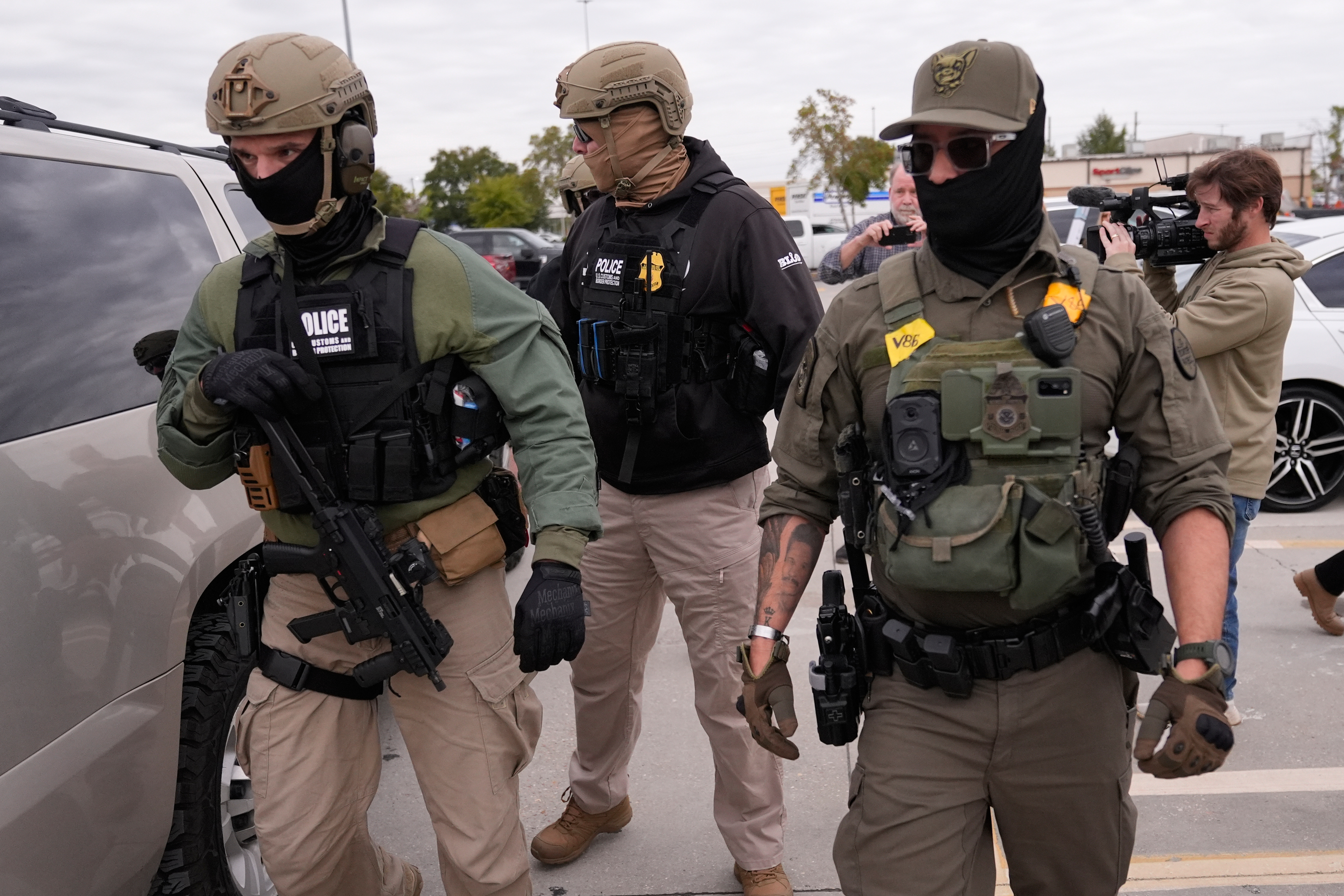 Woman in Medical Scrubs Says She's US Citizen While Being Dragged From Car