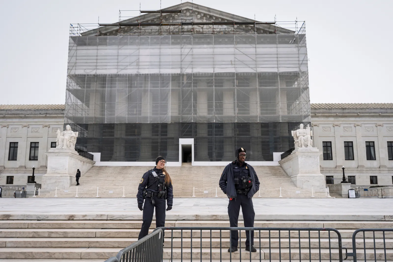 U.S. Supreme Court police officers stand in front of the Supreme Court amid renovations as the justices hear oral arguments on President Donald Trump's push to expand control over independent federal agencies, on Capitol Hill in Washington, on December 8, 2025.