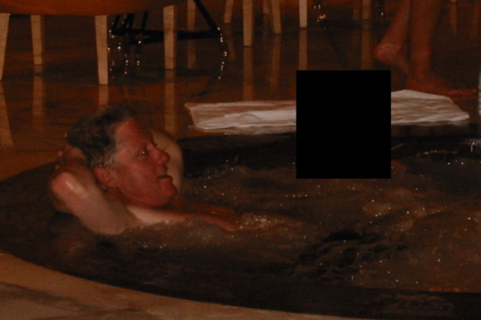 A picture from the first batch of released Epstein files shows former President Bill Clinton in a hot tub with an individual whose face has been redacted.