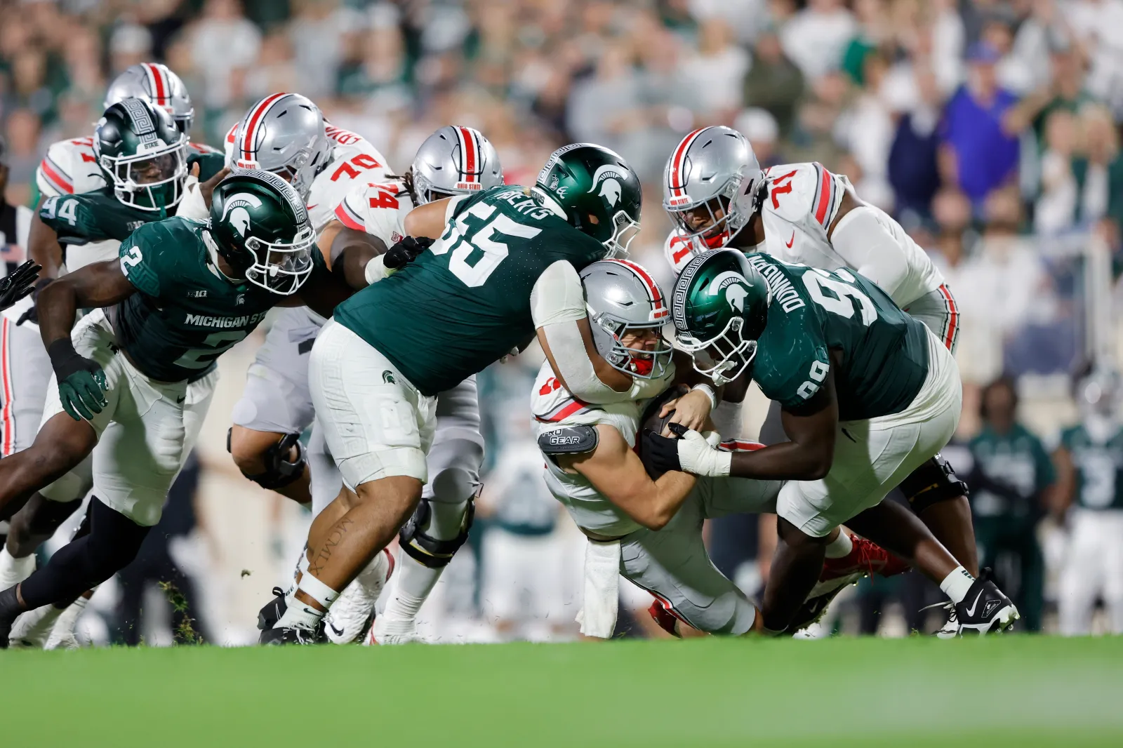 Ben Roberts #55 of the Michigan State Spartans tackles Will Howard #18 of the Ohio State Buckeyes.