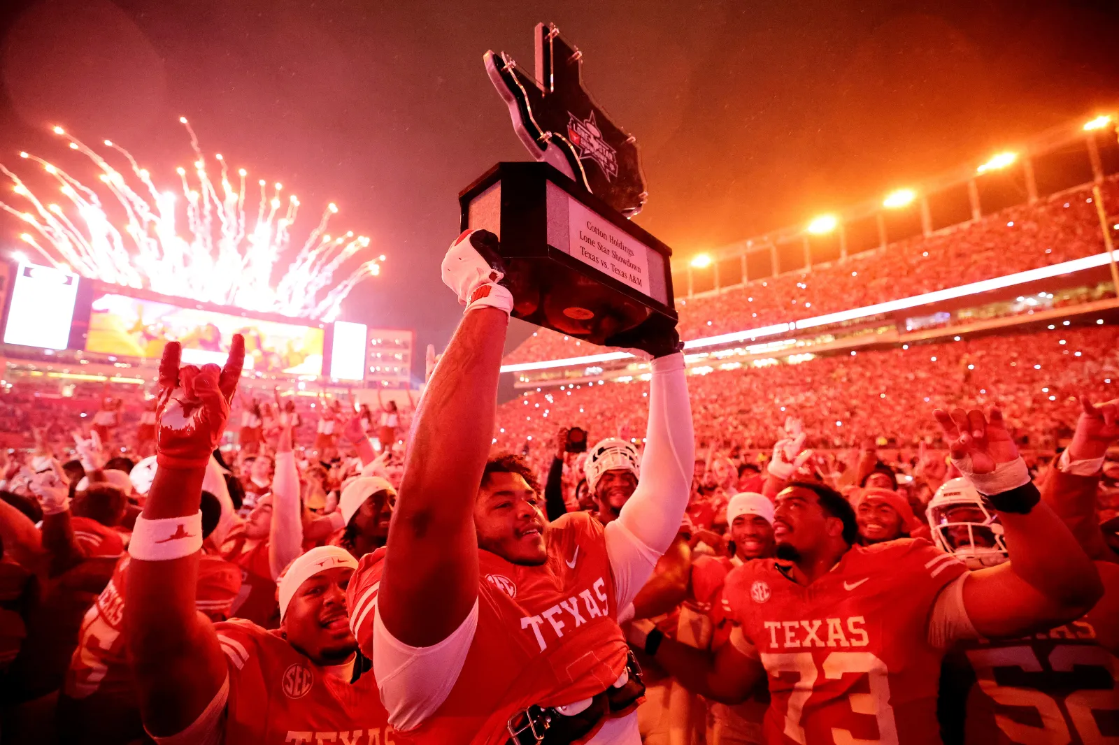 Nick Brooks #71 of the Texas Longhorns hoists the Lone Star Showdown trophy after beating the Texas Aggies 27-17.