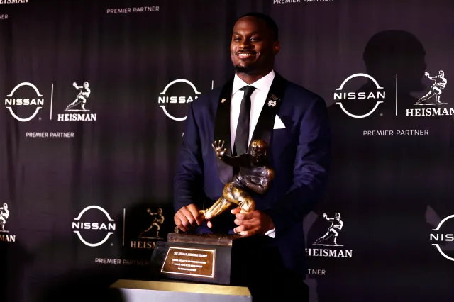 Notre Dame running back Jeremiyah Love poses with Heisman Trophy