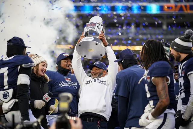 Penn State interim coach Terry Smith celebrates with his team after winning Pinstripe Bowl