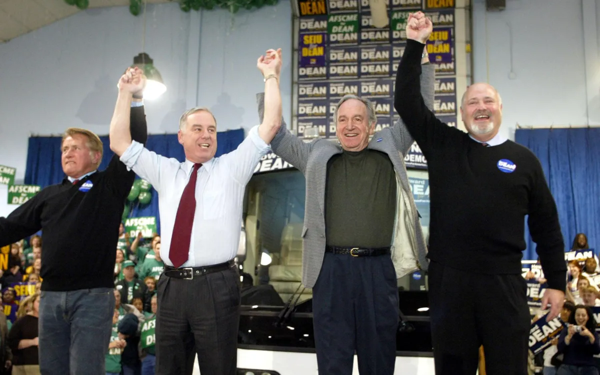 Democratic Presidential candidate Governor Howard Dean holds up the arms of actor Martin Sheen (L) Rob Reiner (R) and Iowa Senator Tom harkin (2nd R) as he kick off his 