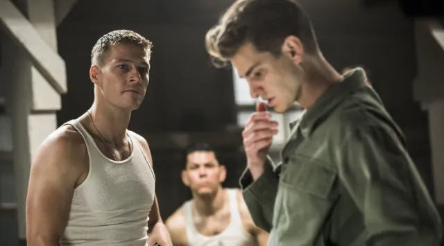 Army men converse in a barracks