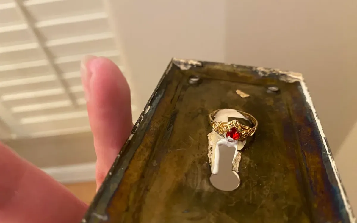 Abbey Gingras found something under a door plate handle.