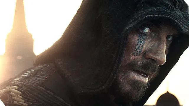A man in a hood looks at the camera