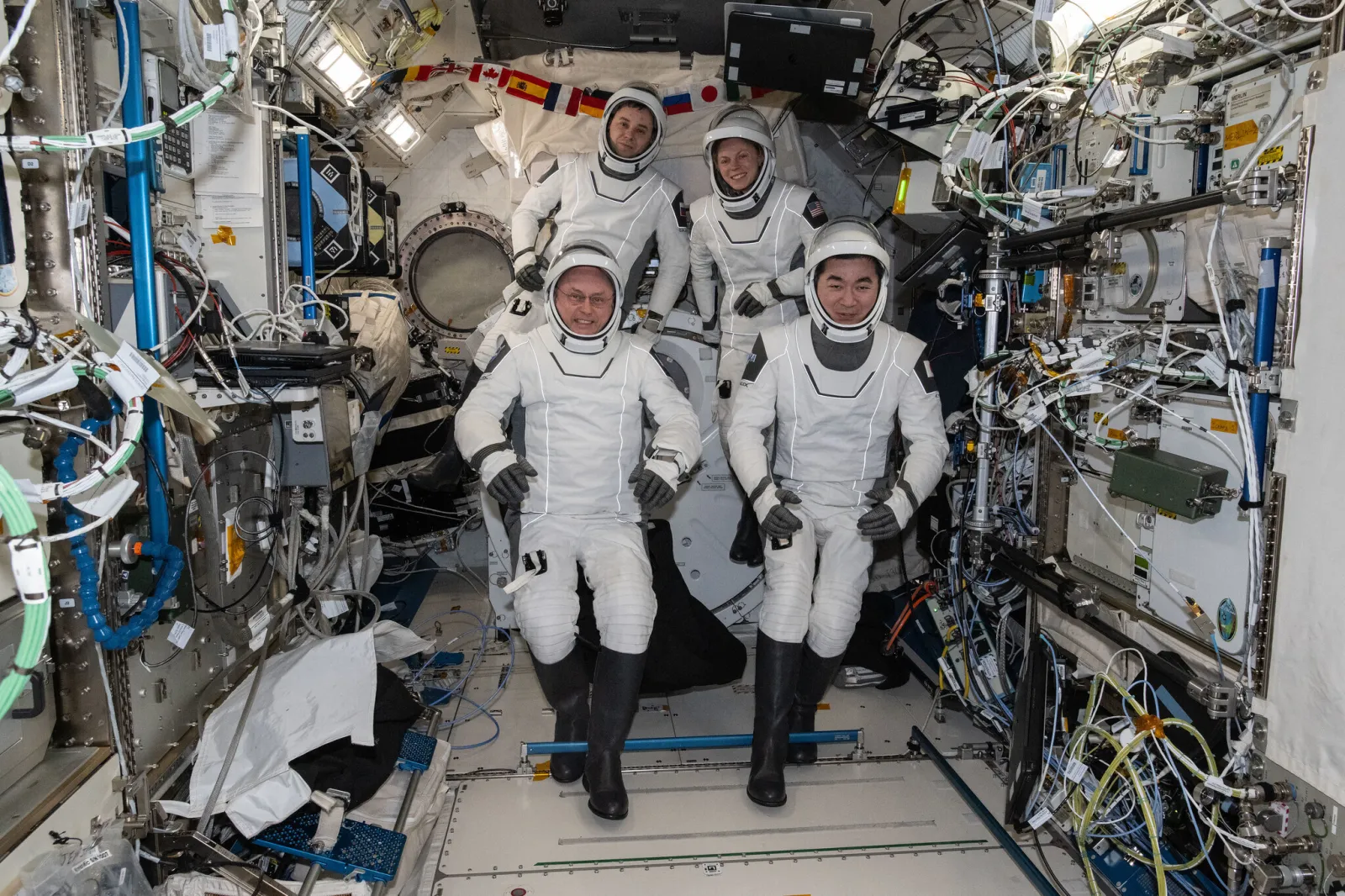 This photo provided by NASA shows clockwise from bottom left are, NASA astronaut Mike Fincke, Roscosmos cosmonaut Oleg Platonov, NASA astronaut Zena Cardman, and JAXA (Japan Aerospace Exploration Agency) astronaut Kimiya Yui gathering for a crew portrait wearing their Dragon pressure suits during a suit verification check inside the International Space Station’s Kibo laboratory module, Wednesday, Jan. 14, 2026.  (NASA via AP)