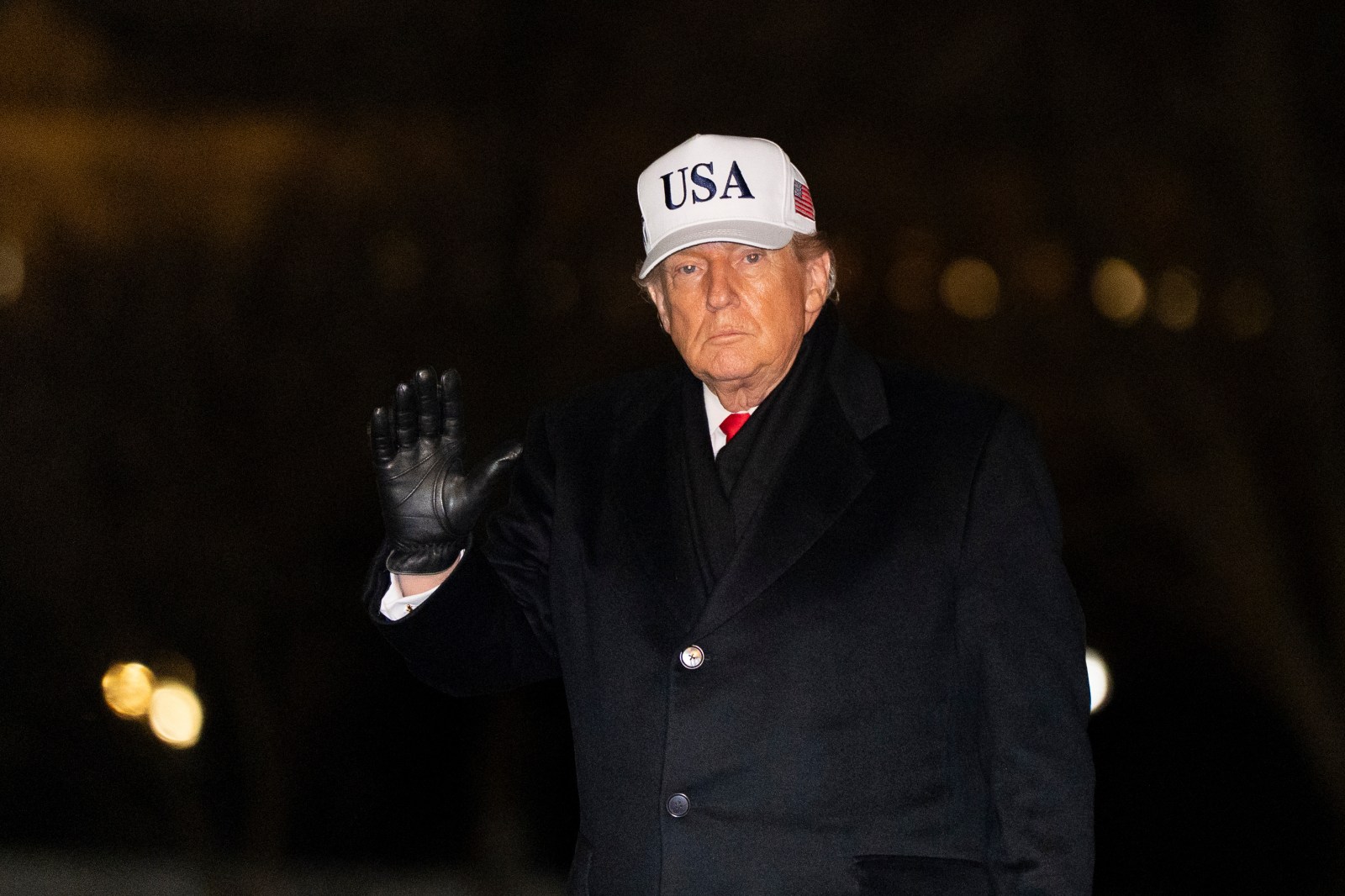 President Donald Trump waves as he walks from Marine One after arriving on the South Lawn of the White House, Tuesday, Jan. 27, 2026, in Washington.
