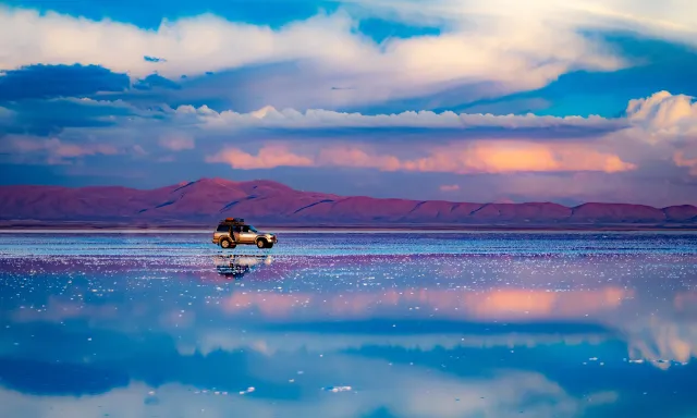 Car shown in the middle of the Salar de Uyuni salt flat in Bolivia
