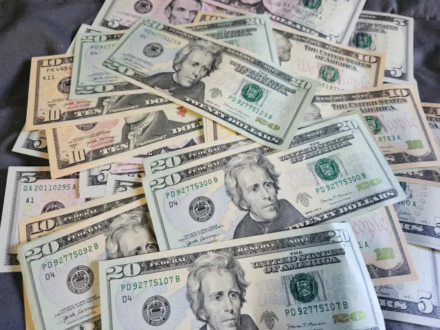 A top down view of a pile of American currency - stock image