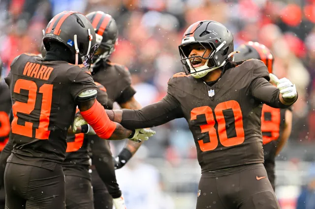 Denzel Ward #21 and Devin Bush #30 of the Cleveland Browns celebrate a stop during the first quarter at Huntington Bank Field on December 07, 2025 in Cleveland, Ohio.