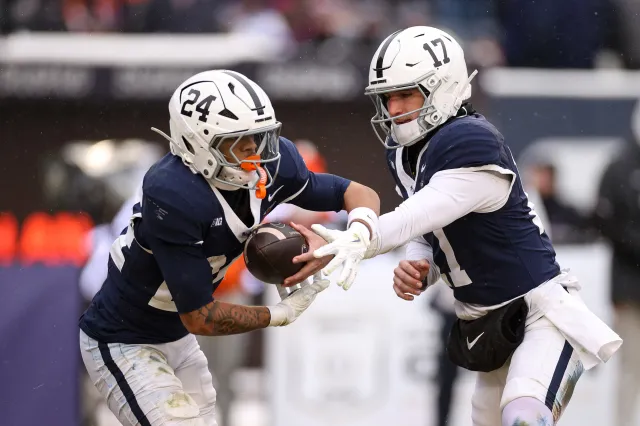 Ethan Grunkemeyer #17 and Corey Smith #24 of the Penn State Nittany Lions run a play during the game against the Clemson Tigers in the 2025 Bad Boy Mowers Pinstripe Bowl - Clemson v Penn State at Yankee Stadium on December 27, 2025 in New York City.