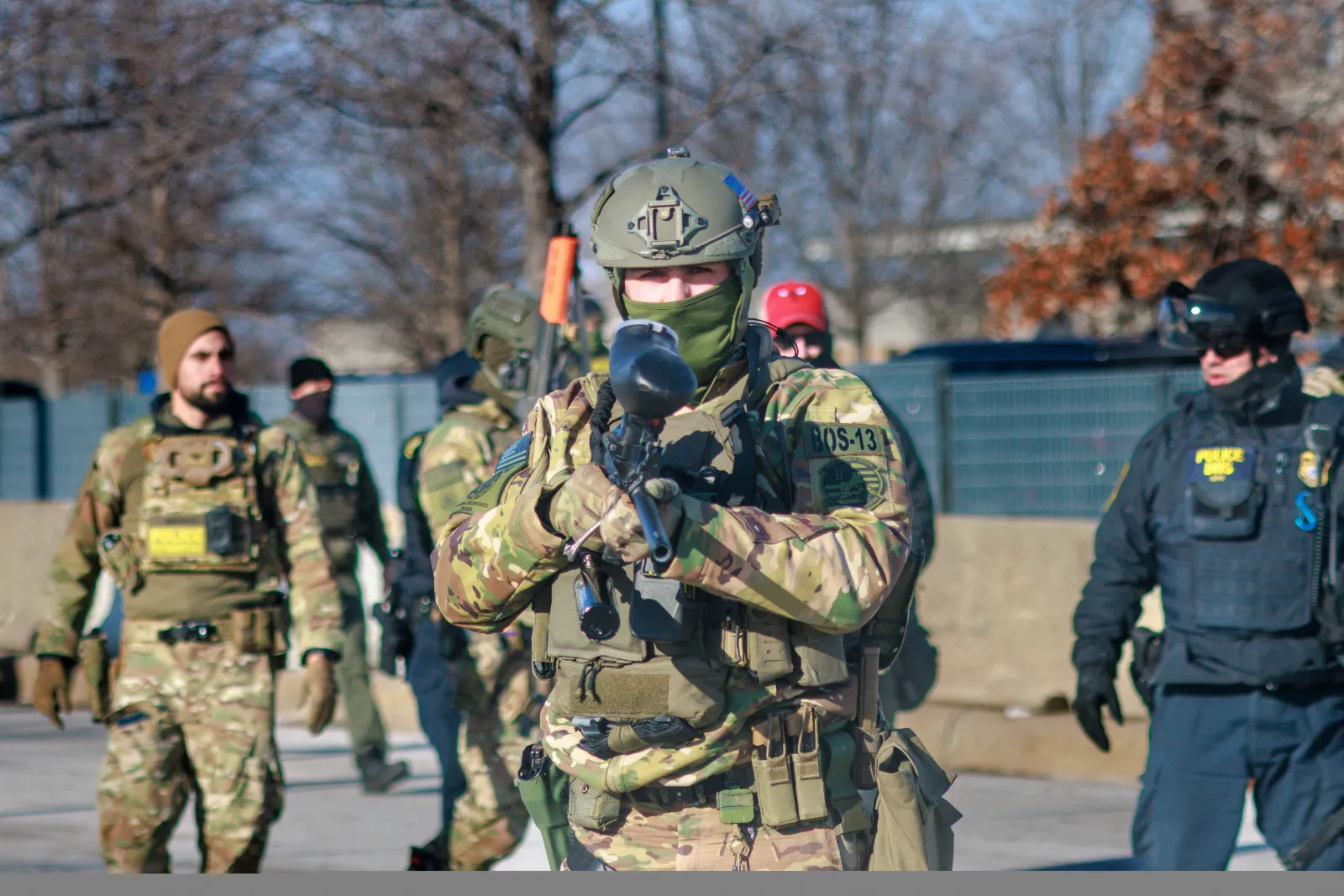 Federal agents advance during an enforcement operation outside the Whipple Building, an ICE facility, in Minneapolis, Minnesota, on January 11, 2026.