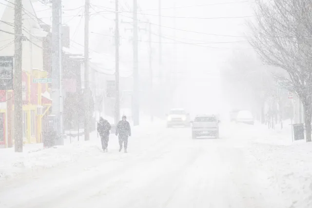 People walk the streets in near whiteout conditions on January 25, 2026 in Louisville, Kentucky