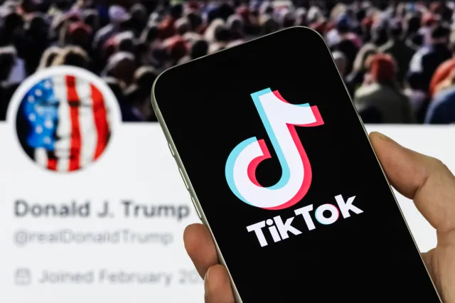 A TikTok logo in front of the Truth Social profile page of U.S. President Donald Trump, on January 23, 2026, in Chongqing, China.