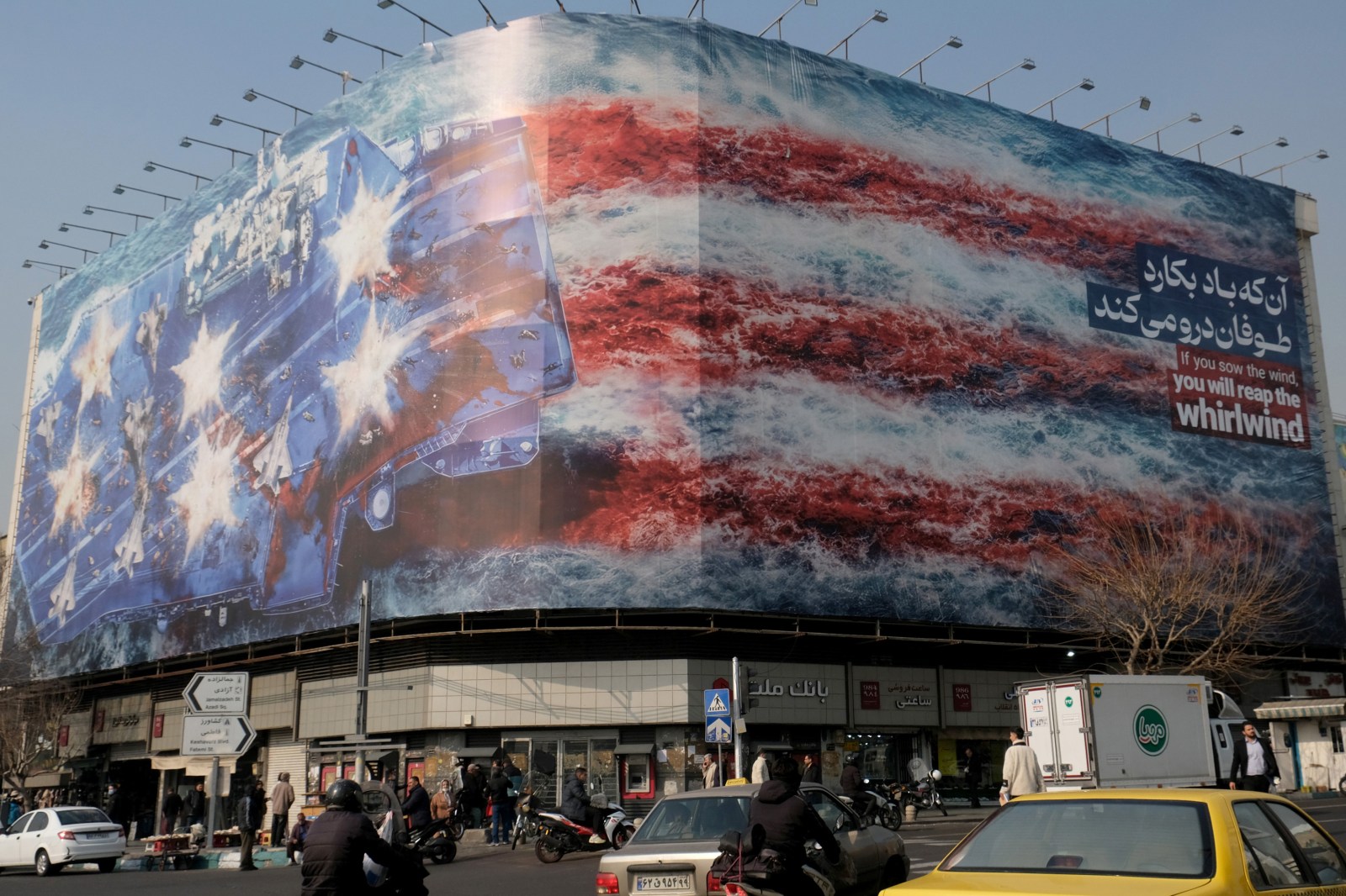 A huge banner displayed in Revolution Square depicts a missile attack on board a US Carrier painted in US flag colors in the Persian Gulf on January 26, 2026 in Tehran, Iran. 
