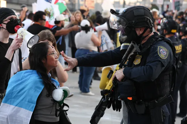 A law enforcement agent places his hand in front of a protestor's face during a "National Shutdown" protest against US Immigration and Customs Enforcement in Los Angeles on January 30, 2026.