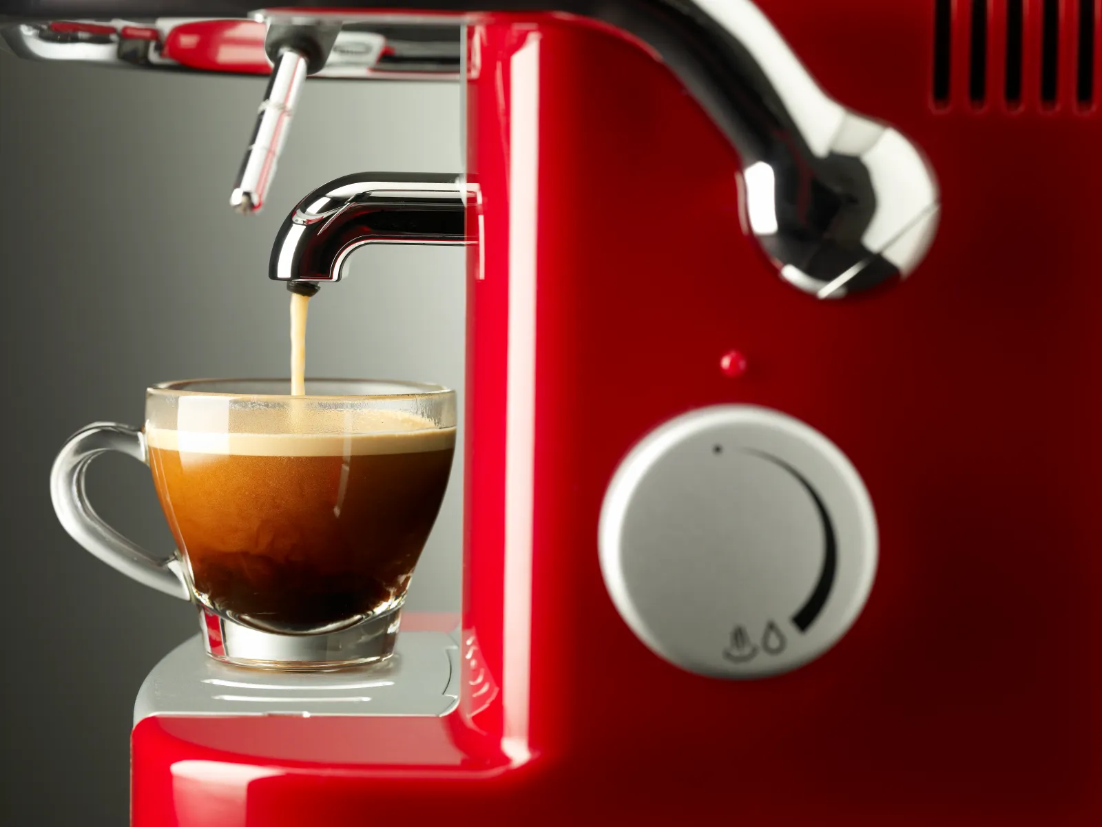 Espresso coffee pouring into cup from machine