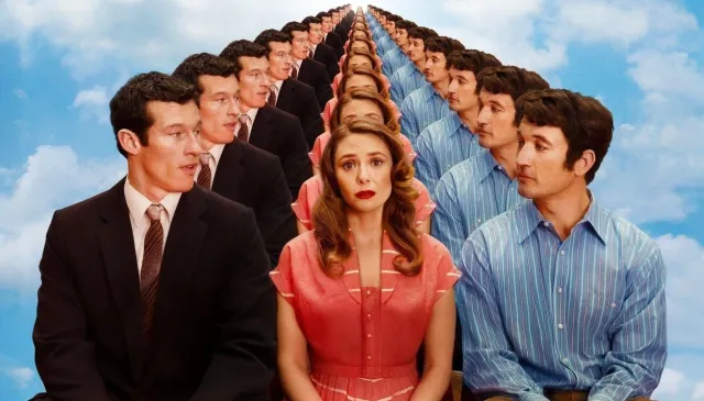 A woman and two men sit looking at each other against a blue sky