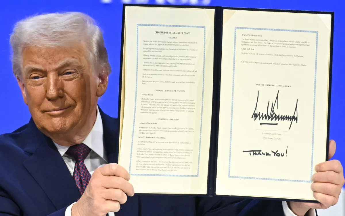 US President Donald Trump holds a signed founding charter at the "Board of Peace" meeting during the World Economic Forum (WEF) annual meeting in Davos on January 22, 2026