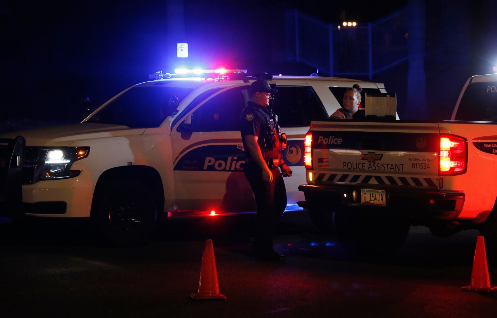 Phoenix Police officers secure a scene of a shooting in Phoenix, Ariz., Sunday, March 29, 2020. At least three Phoenix police officers were shot Sunday night on the city’s north side, authorities said. (AP Photo/Ross D. Franklin)

