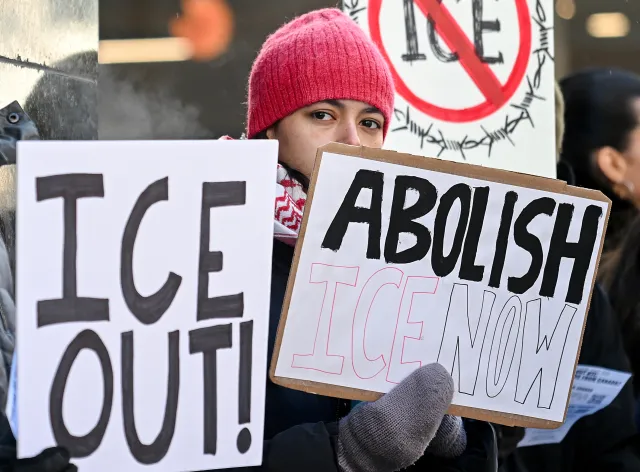 A person takes part in an anti-I.C.E. protest outside the U.S. Consulate in Montreal, Sunday, Feb. 1, 2026.